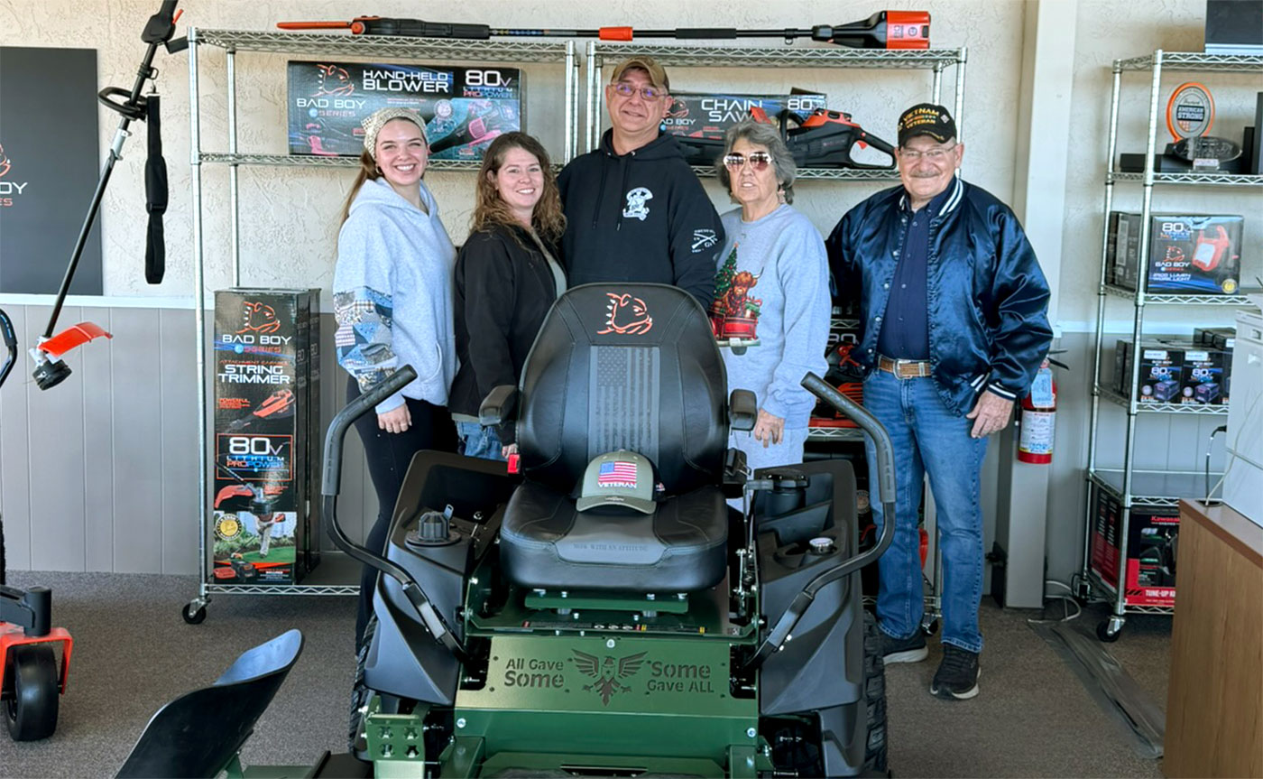 U.S. Army Veteran and Kansas Army National Guardsman Tim Coleman and his family celebrate winning a one-of-a-kind Bad Boy ZT Elite mower as part of a national Veterans Day giveaway.